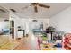 Bright and spacious living room with wood flooring, ceiling fan, and open access to the bedrooms at 2282 Firestone Pl, Winter Haven, FL 33884
