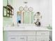 Bright bathroom boasts a double vanity with marble countertops and patterned wallpaper at 2418 W 1St St, Sanford, FL 32771