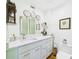 Bright bathroom boasts a double vanity with marble countertops and ornate mirrors at 2418 W 1St St, Sanford, FL 32771