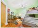 Bright bedroom features a bunk bed, unique decor, and colorful rug on wood floor at 2418 W 1St St, Sanford, FL 32771
