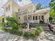 Charming two-story home with a porch, garden, and a gravel driveway at 2418 W 1St St, Sanford, FL 32771