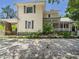 Charming two-story home with a gravel driveway and mature trees at 2418 W 1St St, Sanford, FL 32771