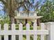 Charming two-story home featuring a white picket fence and mature trees in a serene setting at 2418 W 1St St, Sanford, FL 32771