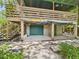 Exterior view of the garage with a roll up door, stairs, and covered entertaining area at 2418 W 1St St, Sanford, FL 32771