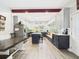 Spacious kitchen with an island, stainless steel appliances, custom cabinetry, and breakfast nook bench seating at 2418 W 1St St, Sanford, FL 32771