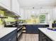 Bright kitchen featuring stainless steel appliances, island seating, updated cabinets, and great natural light at 2418 W 1St St, Sanford, FL 32771