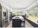 Bright kitchen with island seating, stainless steel appliances, updated cabinets, and stylish fixtures at 2418 W 1St St, Sanford, FL 32771