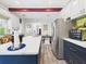 View of the large kitchen island leading to the stainless refrigerator and dining area at 2418 W 1St St, Sanford, FL 32771