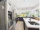 Bright kitchen featuring stainless steel appliances, island seating, updated cabinets, and stylish fixtures at 2418 W 1St St, Sanford, FL 32771