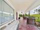 Spacious front porch featuring brick columns and views of the landscaped yard at 2418 W 1St St, Sanford, FL 32771