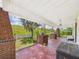 Spacious front porch featuring brick columns and views of the green landscape at 2418 W 1St St, Sanford, FL 32771