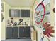 Studio area with stained glass art, upper and lower gray cabinets providing storage and a work surface with natural light at 2418 W 1St St, Sanford, FL 32771