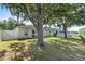 The backyard features a well-maintained lawn, mature trees, and a partial fence at 2505 Brownwood Dr, Mulberry, FL 33860