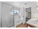 Updated bathroom featuring shower, bathtub, vanity, tile floors, and window at 2505 Brownwood Dr, Mulberry, FL 33860