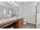 Bathroom with tile floors, vanity, sink, mirror, toilet and glass shower at 2505 Brownwood Dr, Mulberry, FL 33860