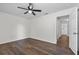 Spacious bedroom features dark wood-look floors and ceiling fan at 2505 Brownwood Dr, Mulberry, FL 33860