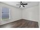 Bedroom with wood-look floors and natural light from window at 2505 Brownwood Dr, Mulberry, FL 33860