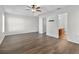 This spacious bedroom has wood-look floors, ceiling fan, and ensuite bathroom access at 2505 Brownwood Dr, Mulberry, FL 33860