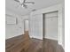 Bright bedroom features wood-look floors, ceiling fan, closet, and white trim at 2505 Brownwood Dr, Mulberry, FL 33860