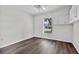 This bedroom has wood-look flooring, a window, and storage cabinets at 2505 Brownwood Dr, Mulberry, FL 33860