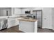 Bright kitchen featuring white cabinets, stainless steel appliances, and a center island at 2505 Brownwood Dr, Mulberry, FL 33860