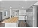 Bright kitchen featuring white cabinets, stainless steel appliances, and a butcher block island at 2505 Brownwood Dr, Mulberry, FL 33860