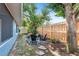 Private backyard seating area with Adirondack chairs, surrounded by lush greenery and a wooden fence at 4125 Sunny View Dr, Lakeland, FL 33813