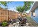 The fenced backyard has a fire pit and seating at 4125 Sunny View Dr, Lakeland, FL 33813