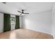 An empty bedroom has a ceiling fan, neutral walls, and updated flooring at 4125 Sunny View Dr, Lakeland, FL 33813