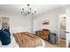This bedroom has neutral paint, an updated light fixture, and an attached bathroom at 4125 Sunny View Dr, Lakeland, FL 33813