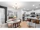 Open-concept kitchen with white cabinets, granite countertops, stainless appliances, and an adjacent dining area at 4125 Sunny View Dr, Lakeland, FL 33813