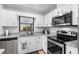 Kitchen with stainless appliances, granite counters, and white cabinets at 4125 Sunny View Dr, Lakeland, FL 33813