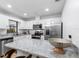 Bright kitchen featuring white cabinets, granite countertops, a breakfast bar, and stainless steel appliances at 4125 Sunny View Dr, Lakeland, FL 33813