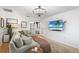 Spacious living room with a comfortable sectional, modern decor, and views of an adjacent room and a mounted TV at 4125 Sunny View Dr, Lakeland, FL 33813
