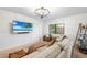 Cozy living room with neutral tones, comfortable seating, mounted television, and natural light at 4125 Sunny View Dr, Lakeland, FL 33813