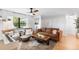 Modern living room boasts a leather sofa, stylish decor, and a large window with natural light at 4125 Sunny View Dr, Lakeland, FL 33813