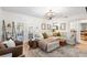 Cozy living room featuring a sectional sofa, stylish decor, and French doors leading to an outdoor patio at 4125 Sunny View Dr, Lakeland, FL 33813