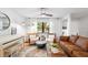 Bright living room features a white piano, modern furniture, and a large window with natural light at 4125 Sunny View Dr, Lakeland, FL 33813