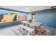 Inviting screened patio with rustic dining table, chairs, bench and views of the fenced yard at 4125 Sunny View Dr, Lakeland, FL 33813