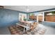 Inviting screened patio with rustic dining table, chairs, bench and views of the fenced yard at 4125 Sunny View Dr, Lakeland, FL 33813