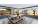 Inviting screened patio with rustic dining table, chairs, bench and views of the fenced yard at 4125 Sunny View Dr, Lakeland, FL 33813