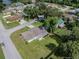 A high aerial view of a white house with a brown roof on a large lot in a mature neighborhood at 4921 Sharon Ave, Lakeland, FL 33812