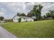 Exterior view of the house shows its well-maintained lawn and landscaping at 4921 Sharon Ave, Lakeland, FL 33812