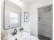 Modern bathroom featuring a sleek vanity, stylish mirror, and walk-in shower with patterned tile at 4921 Sharon Ave, Lakeland, FL 33812