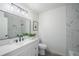 Elegant bathroom with a modern vanity, large mirror, and a walk-in shower with marble-style tile at 4921 Sharon Ave, Lakeland, FL 33812