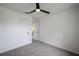 Clean, carpeted bedroom with white walls, ceiling fan, and closet at 4921 Sharon Ave, Lakeland, FL 33812