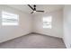 Cozy bedroom with neutral carpet and natural light from two windows with a ceiling fan at 4921 Sharon Ave, Lakeland, FL 33812