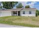 Inviting single-story home boasts a fresh white brick exterior, attached garage, and well-kept lawn at 4921 Sharon Ave, Lakeland, FL 33812