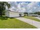 This charming home boasts a well-manicured lawn and a long driveway leading to a garage at 4921 Sharon Ave, Lakeland, FL 33812
