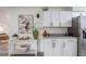 Bright kitchen features white cabinets, granite countertops, and stainless steel refrigerator at 4921 Sharon Ave, Lakeland, FL 33812